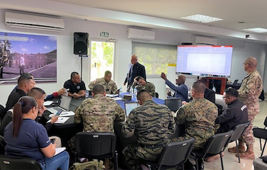 a picture of personnel and soldiers in uniform participating in the workshop