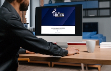 a picture of a man browsing the ISG Heron on his desktop