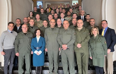 A picture of a group of men and women standing on stair steps