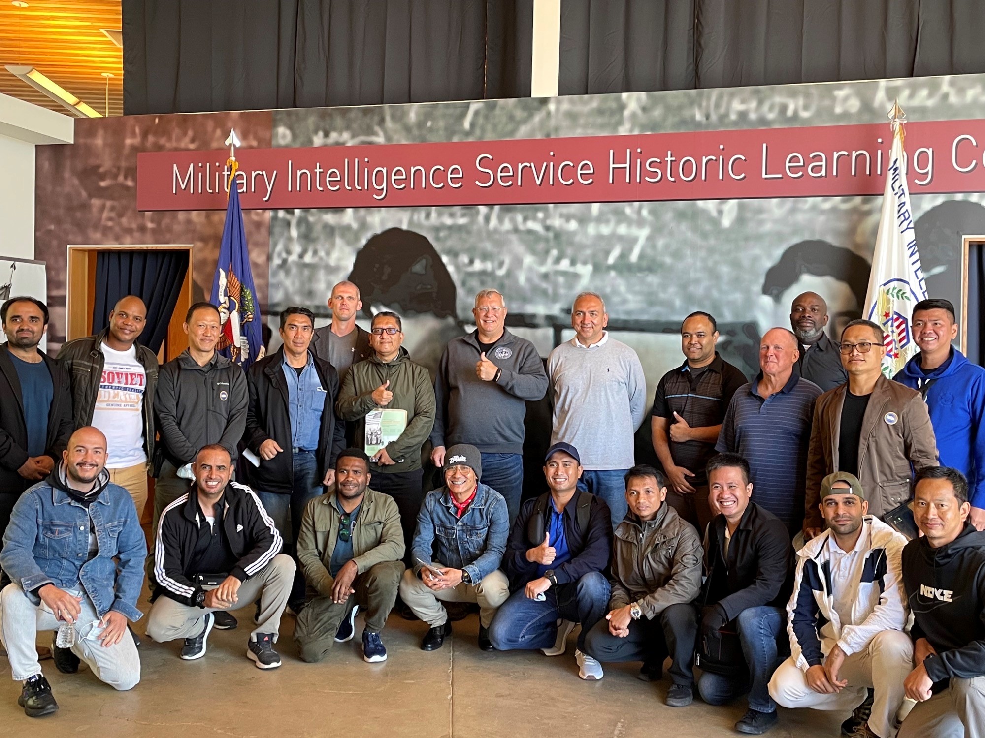 A group of various international participants posing in front of Military Intelligence Service Historic Learning