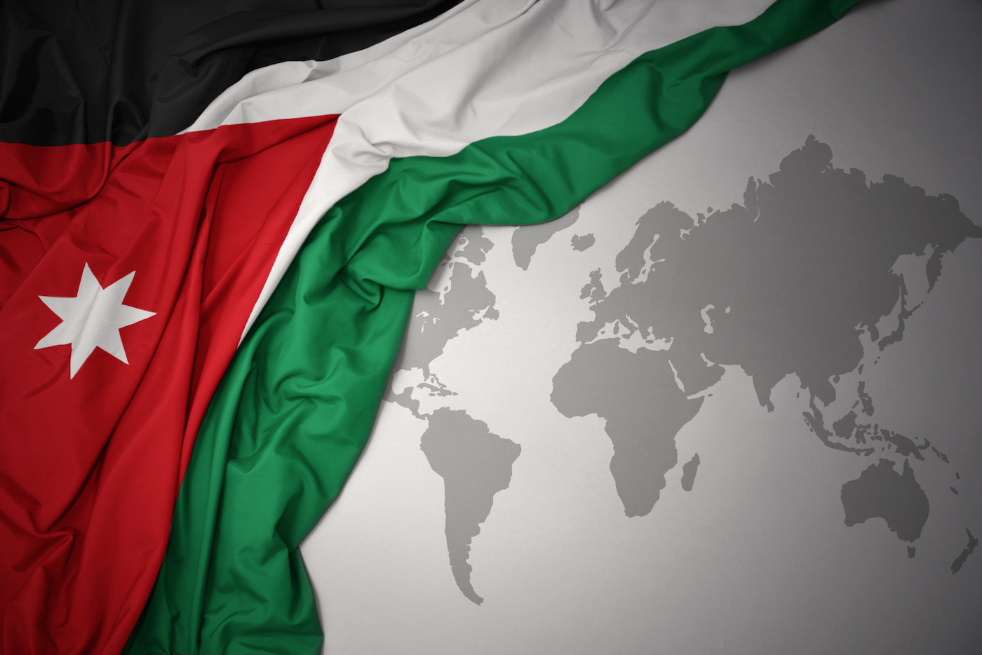 a picture of the flag of Jordan hovering over a grey globe