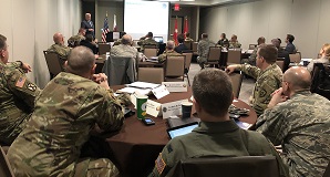 West Virginia National Guard members sitting at tables in workshop