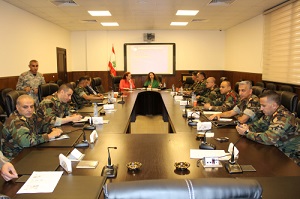 Men in uniform sitting around a table